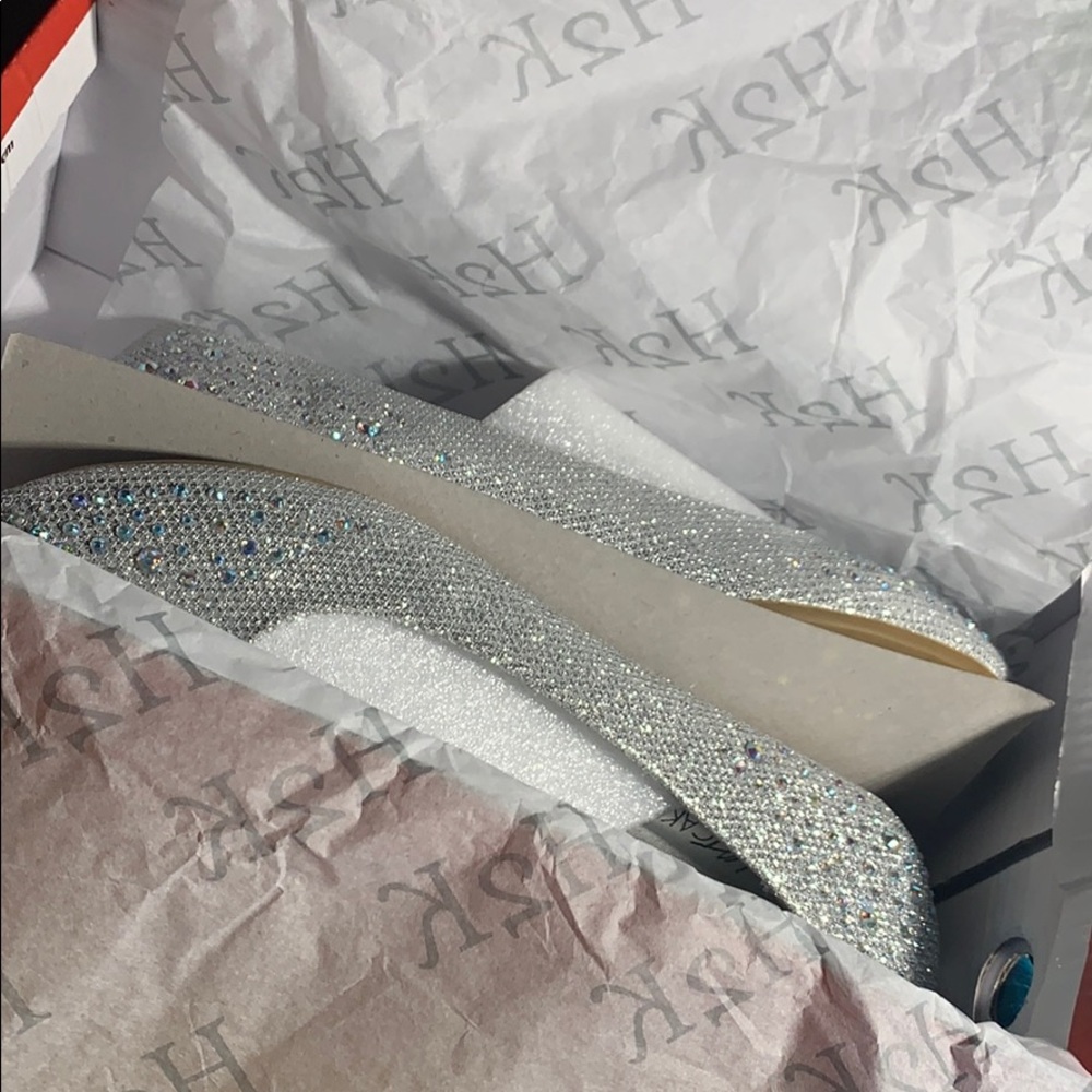 Silver flat shoes.